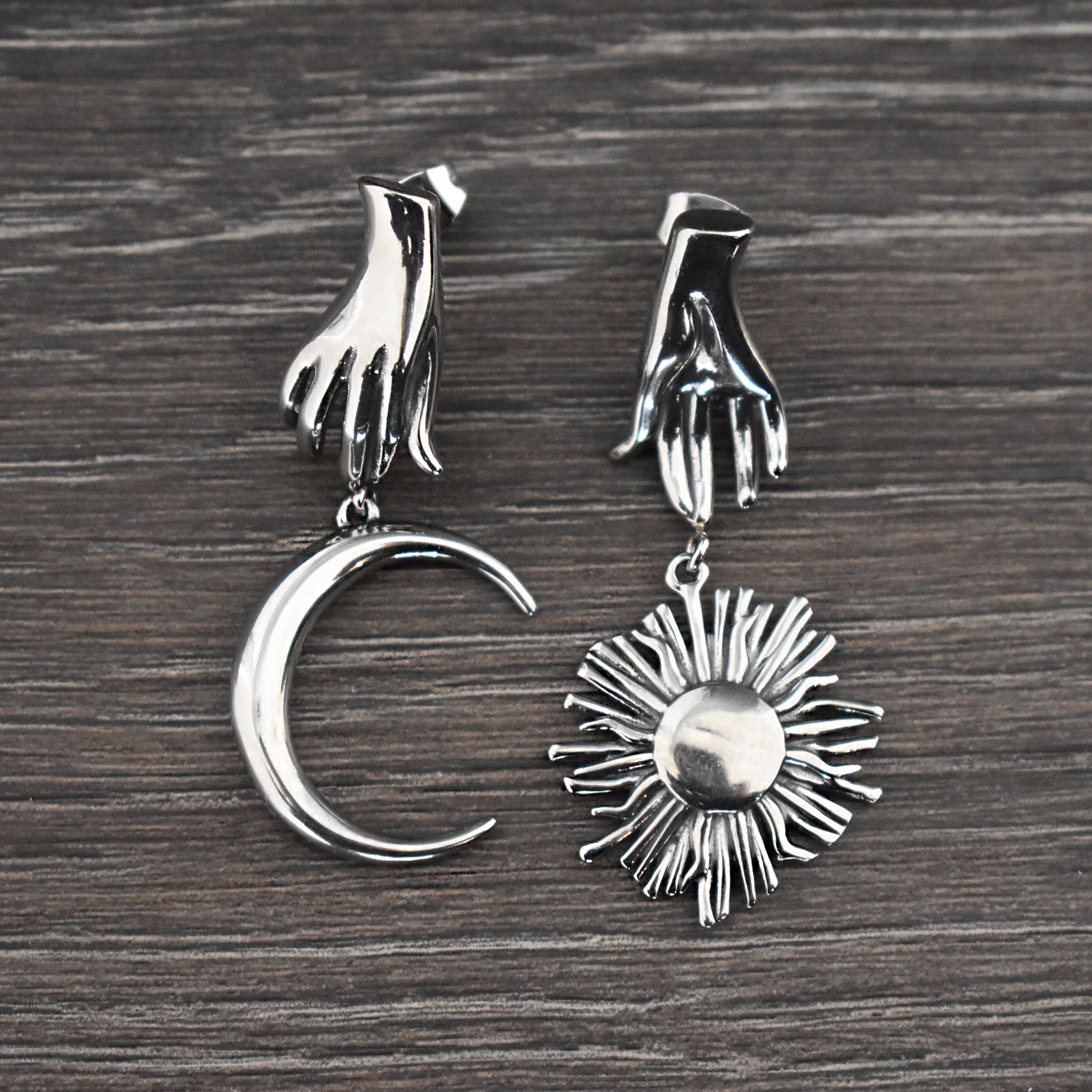 Mismatched Hand holding Sun and Moon earrings