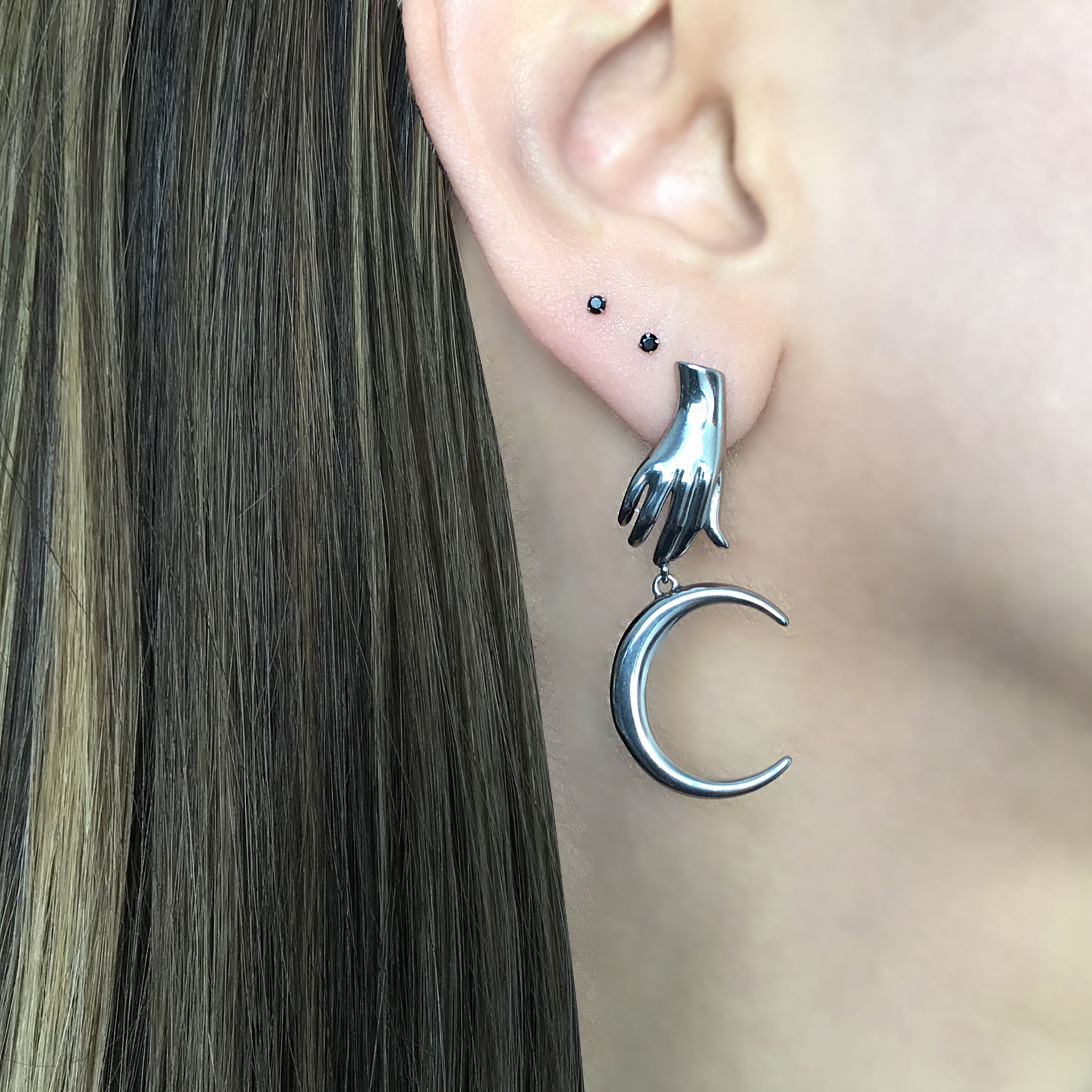 Mismatched Hand holding Sun and Moon earrings