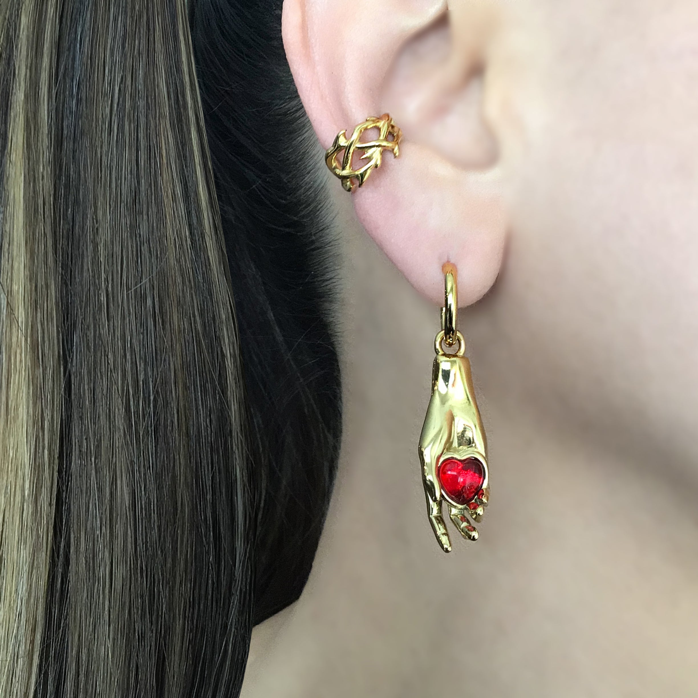 Hand holding Heart hoop earrings in Silver