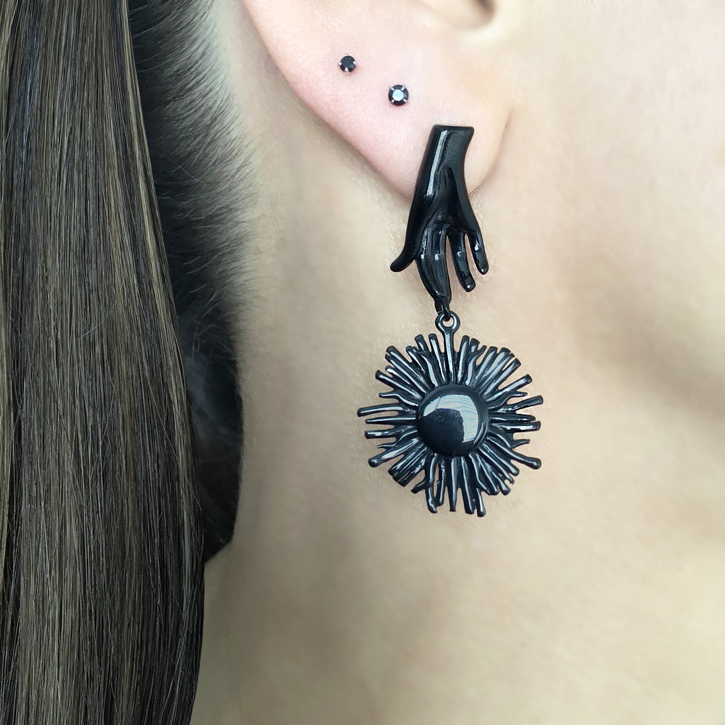 Mismatched Hand holding Sun and Moon earrings