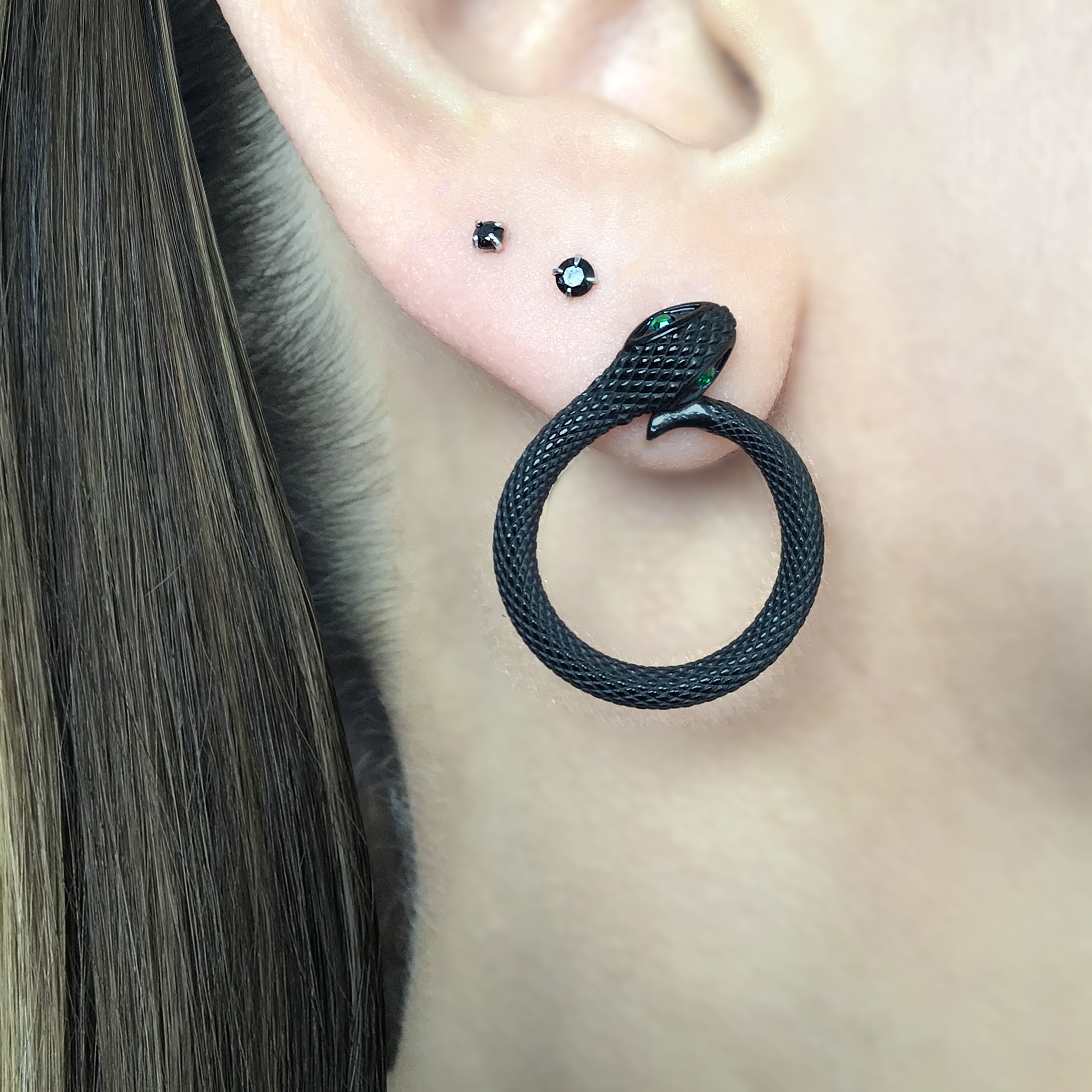 Snake stud earrings with Emerald CZ stones